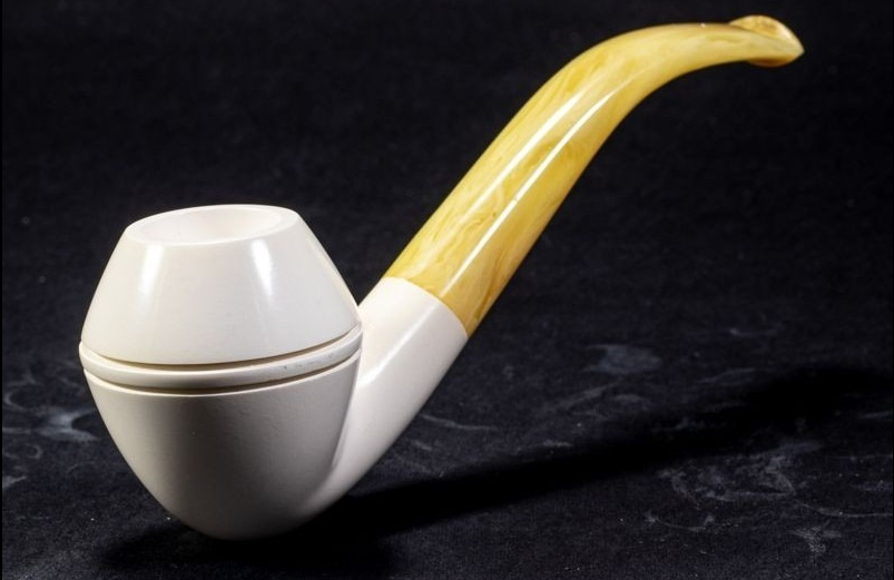 Elegant Meerschaum Bent Bulldog pipe featuring a sleek white bowl and a gently curved amber stem, displayed against a dark backdrop